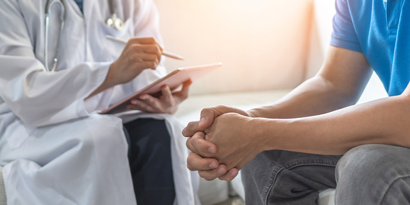 person examining foot with corn on skin using gloved hand for treatment seven tips for foot care